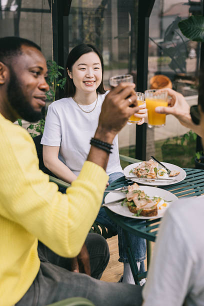 A joyful toast among friends during brunch in a modern cafe