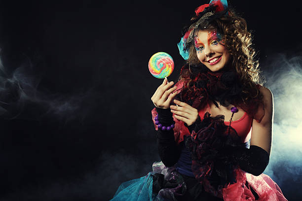 istock woman with creative make-up in doll style with candy. 2220110417