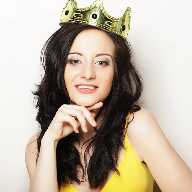 istock pretty brunette woman wearing crown 2220110834
