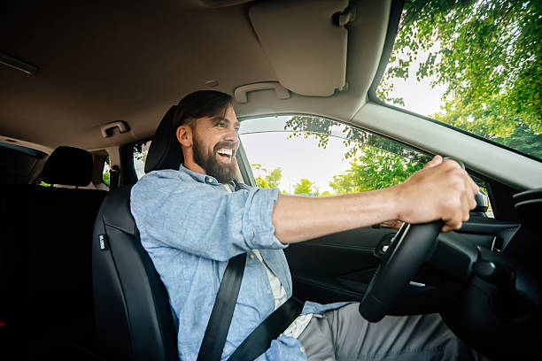 istock A handsome smiling man driving a car. 2220113558