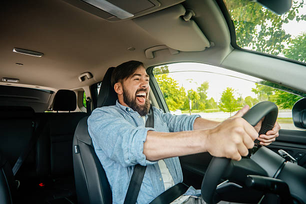 istock A handsome smiling man driving a car. 2220113575