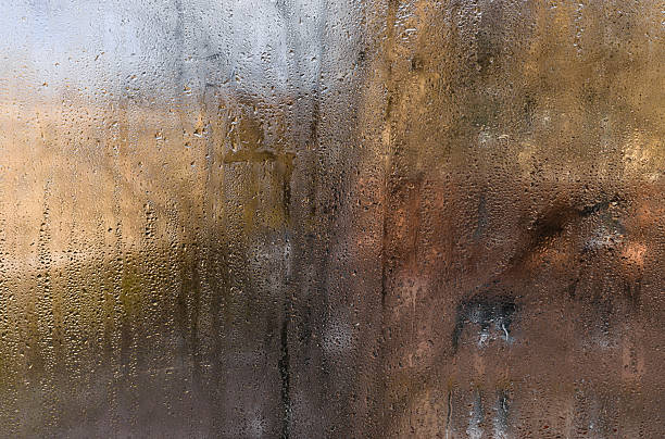 istock Condensation forms water drops on indoor window glass, showing high humidity. 2220114031