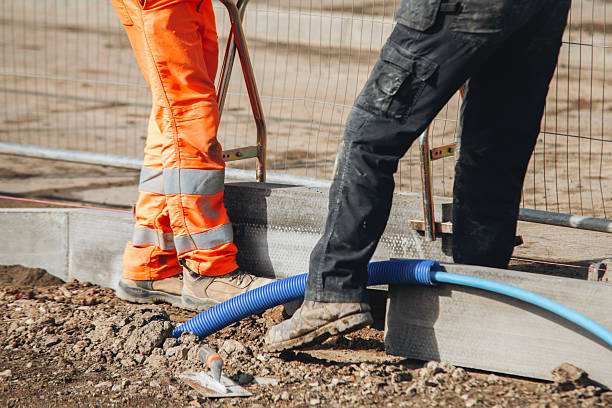 istock Setting road border kerb stone before laying new asphal 2220115626