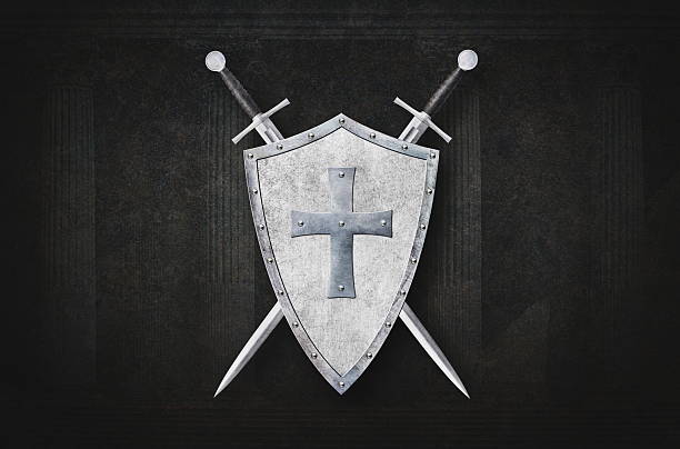 istock shield decorated with metal cross and two swords on dark background 2220116983
