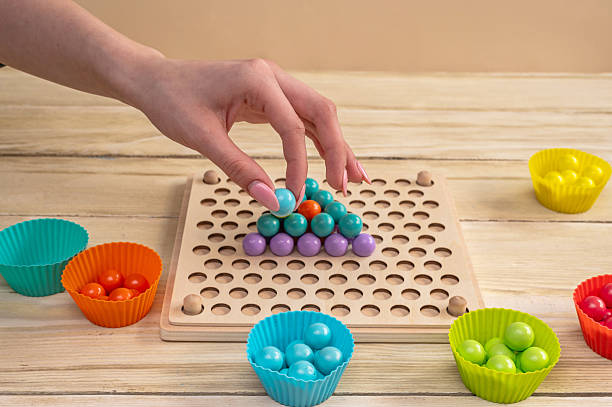 istock Wooden Montessori sorting board with colorful balls develops fine motor skills. 2220120857