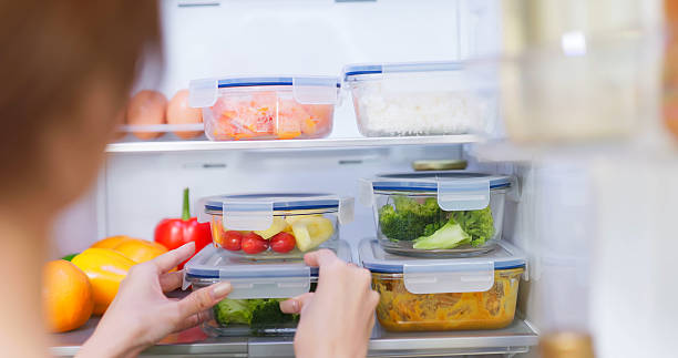 istock Asian Woman Storing Food fridge 2220121222