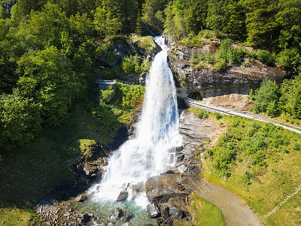 istock The famous Steinsdalsfossen waterfall in Norway, drone view. A tourist path allows walking behind the powerful stream of water. 2220121597
