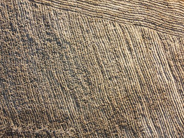 istock Patterns of sand created by tide changes on a beach in the early morning light 2220121742