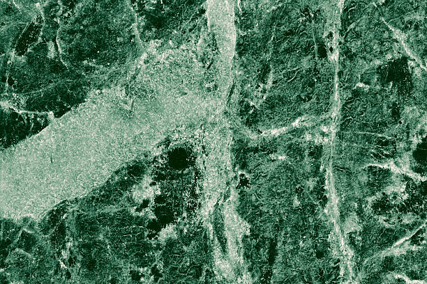 Rendered under soft light, this jade tone marble surface featuring intricate mineral veins, perfect for architectural render surfaces.