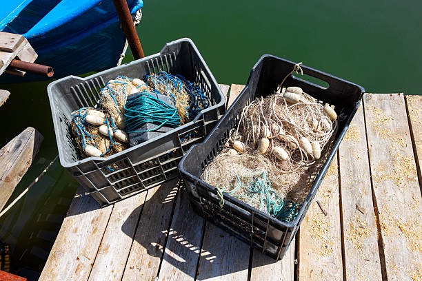 istock Two plastic crates with fishing nets on a fishing pier 2220122583
