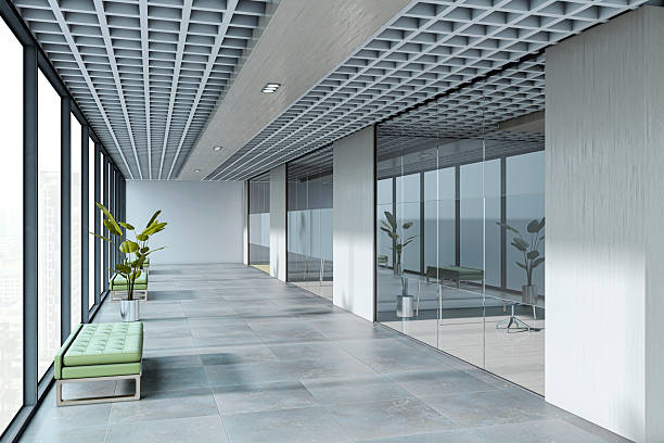 Empty office corridor with modern interior design, glass walls, tiled floor, grid ceiling, green benches, cityscape background. 3D Rendering