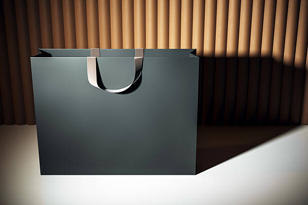 istock Luxury shopping bag mockup with blank surface and modern design placed on light floor against elegant wooden background for branding presentation. 3D Rendering 2220122839