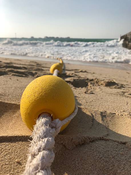 istock Small yellow buoy on a beach in Dubai 2220122899