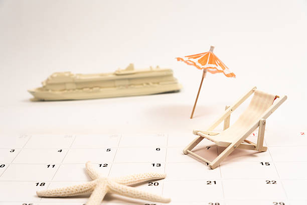 istock Miniature cruise ship resting beside deckchair, starfish on calendar, symbolizing summer vacation planning 2220122945