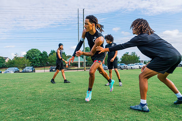 istock Youth Football Team Warming Up Practicing Drills, Two-Hand Touch 2220126221