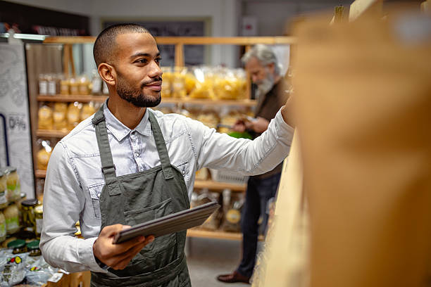 istock African American Grocery Worker Using Digital Tablet For Inventory Management In Modern Store 2220128521