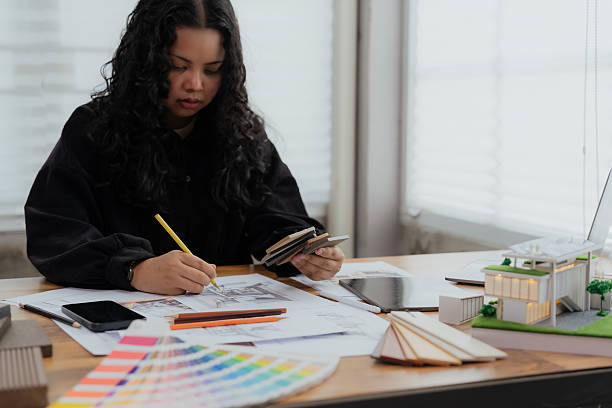 istock An architect carefully sketching a blueprint for an interior design and construction project at her modern workspace 2220130299