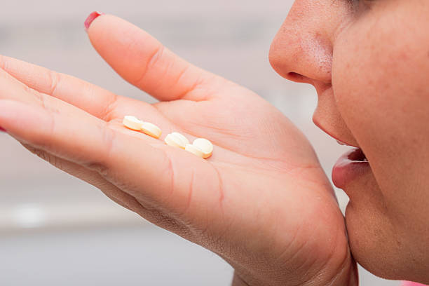 istock Latina Woman with Mouth Open and Excessive Pill 2220131167