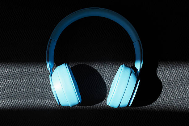 istock Blue headphones are placed on yoga mat surface. Light streams across them. 2220133320