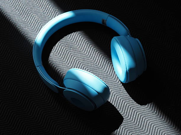 istock Blue headphones are placed on yoga mat surface. Light streams across them. 2220133321