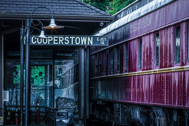 Retired railroad car on display at the building that was once the train depot in Cooperstown, New York.  The tracks leading to and from the building no longer exist.  Photo taken on September 7, 2024.