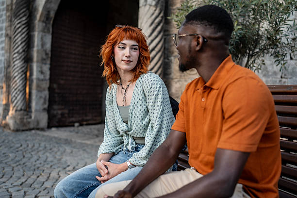 istock Two Friends Sitting on a Bench and Engaging in Thoughtful Conversation 2220134730
