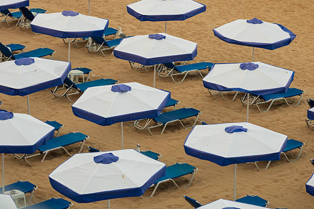 Beach deckchairs with umbrellas at tropical relax beach