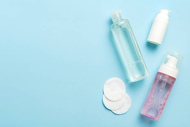 istock Micellar cleansing water and discs to remove cosmetics and cleanse the skin on colored background. Copy space top view 2220141030