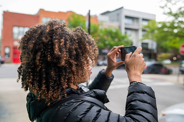Woman seen using her cellphone to take photo