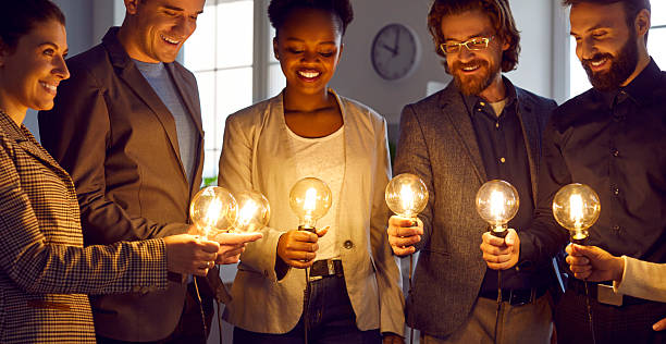istock Team of business people with light bulbs work together and develop creative ideas 2220141609