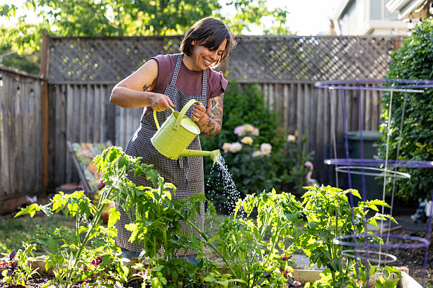 Woman relaxing outdoors in her vegetable and flower garden.