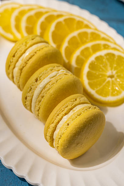 istock Delicious yellow lemon macarons with lemon slices on white plate 2220142301