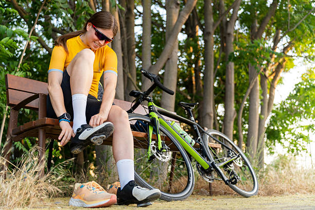 istock Professional cyclist putting on cycling shoes before training ride 2220142669