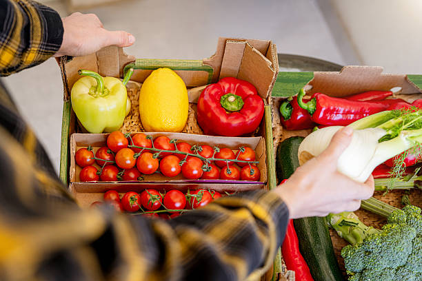 istock Unpacking fresh organic produce from delivery box top view 2220142683