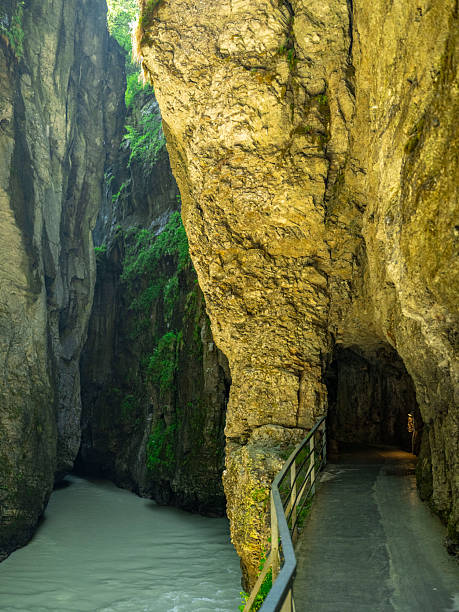 istock A narrow river flows between towering rock walls in a Swiss gorge 2220144152