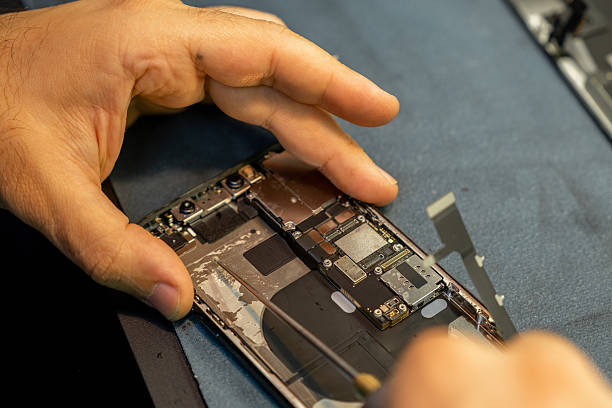 istock Expert Phone Repair in Progress With Detailed Attention to Internal Components at a Workshop 2220144694