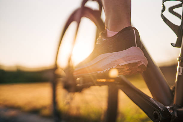 istock Cyclist pedaling at sunset in the countryside 2220145897