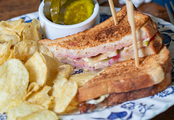 Ham and cheese toastie with crisps and pickles