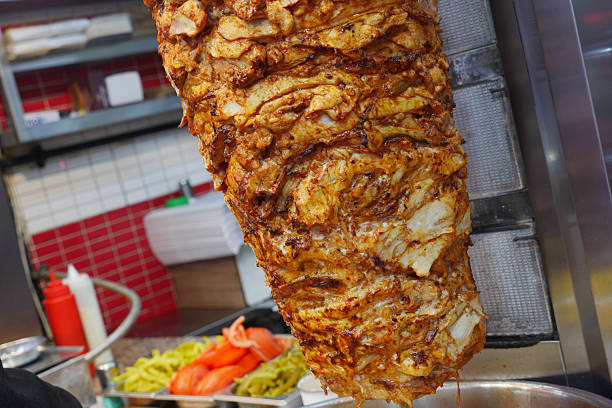 istock Tasty shawarma on vertical grill in busy kitchen during lunch rush 2220146760