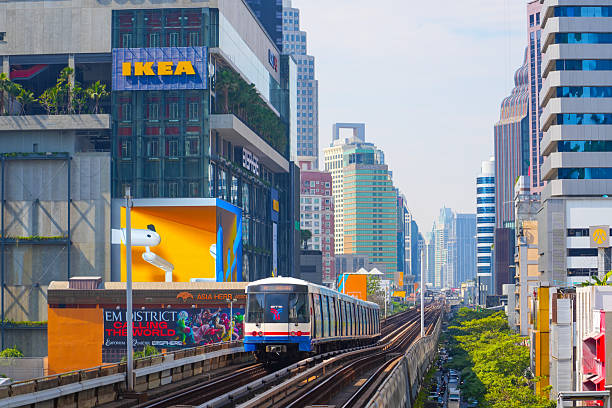 View of Bangkok skyline and skyscraper with BTS skytrain BTS sky train runs through the station Saphan Taksin Thailand. 26 december 2023.