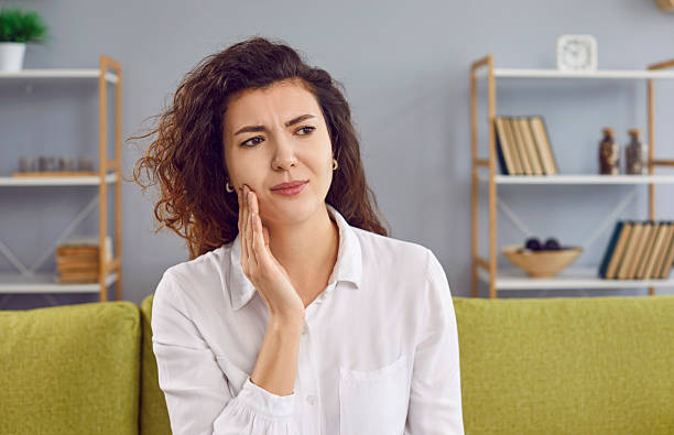 istock Beautiful young woman feeling toothache having dental problem 2220148262