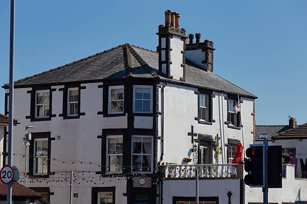 istock A white building with dark trim stands against a clear blue sky. 2220149833