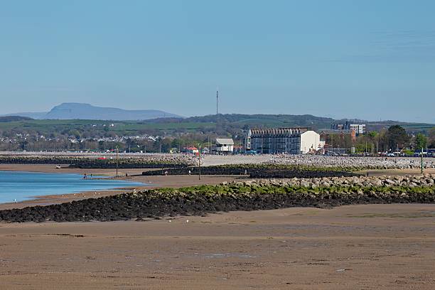 istock A serene coastal landscape features a sandy foreground, a glimpse of blue water. 2220150252