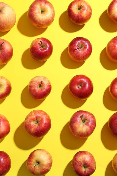 istock Flat lay composition with many red apples on yellow background 2220151099