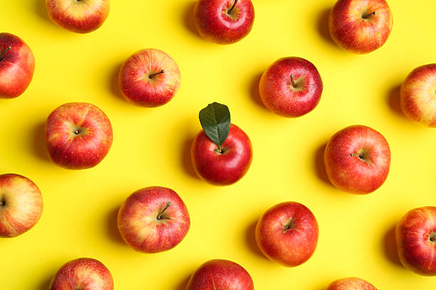 istock Flat lay composition with many red apples on yellow background 2220151127
