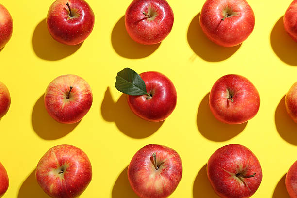 istock Flat lay composition with many red apples on yellow background 2220153249