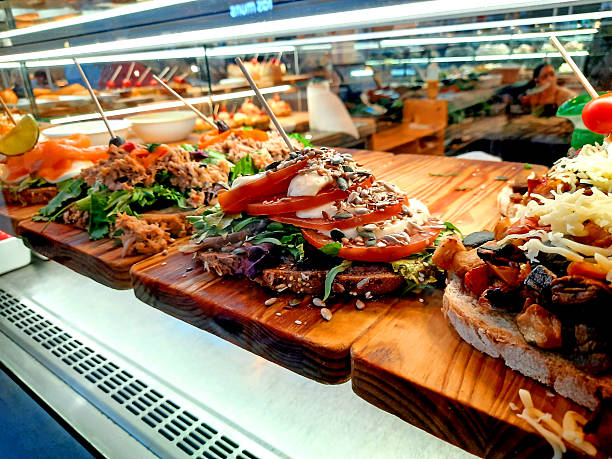istock Colorful Open Sandwiches with Fresh Toppings Displayed in Restaurant Showcase 2220153498