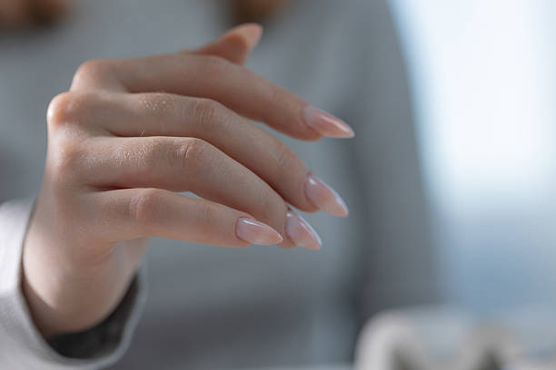 istock Quiet luxury manicure on elegant hand in salon, light tones with professional tools 2220155006