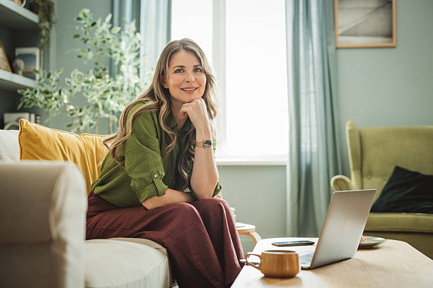 istock Mature woman using laptop at home 2220157909