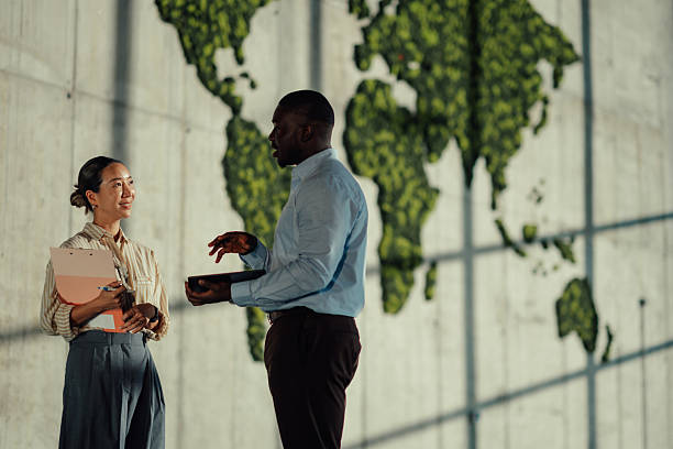 istock Managers discussing global business strategy near green world map 2220160475